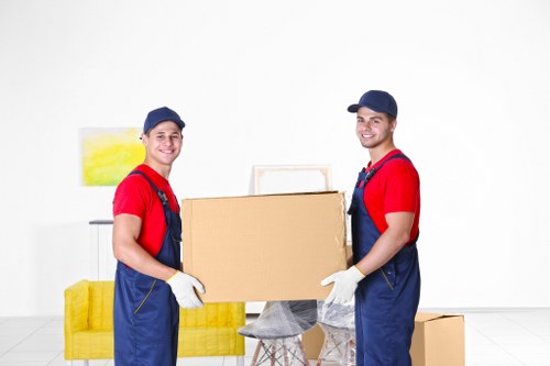 Furniture and boxes being loaded into a moving van for a home move in Belgium