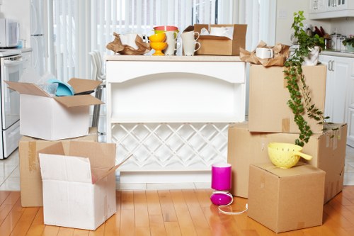 Staff wearing PPE while handling furniture during a removal job